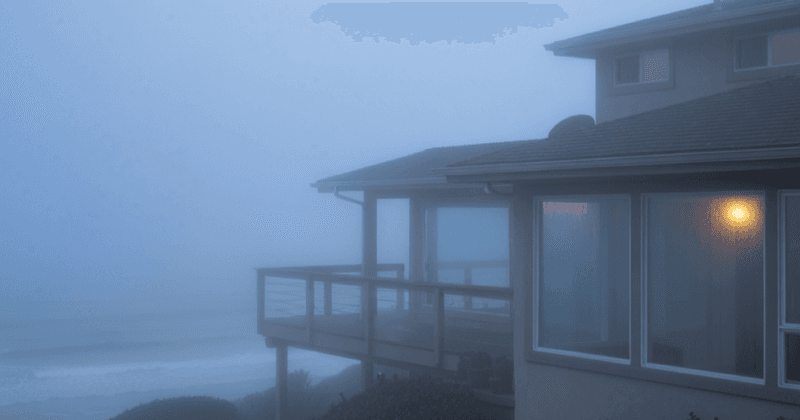 Morning marine layer fog rolling over San Diego coastal homes in Point Loma with humidity and mold prevention illustration
