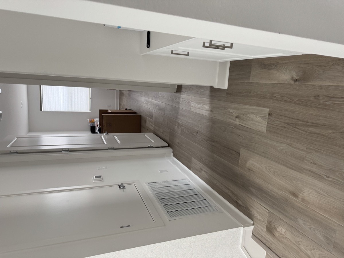 New wood plank flooring hallway — post-construction dust extraction